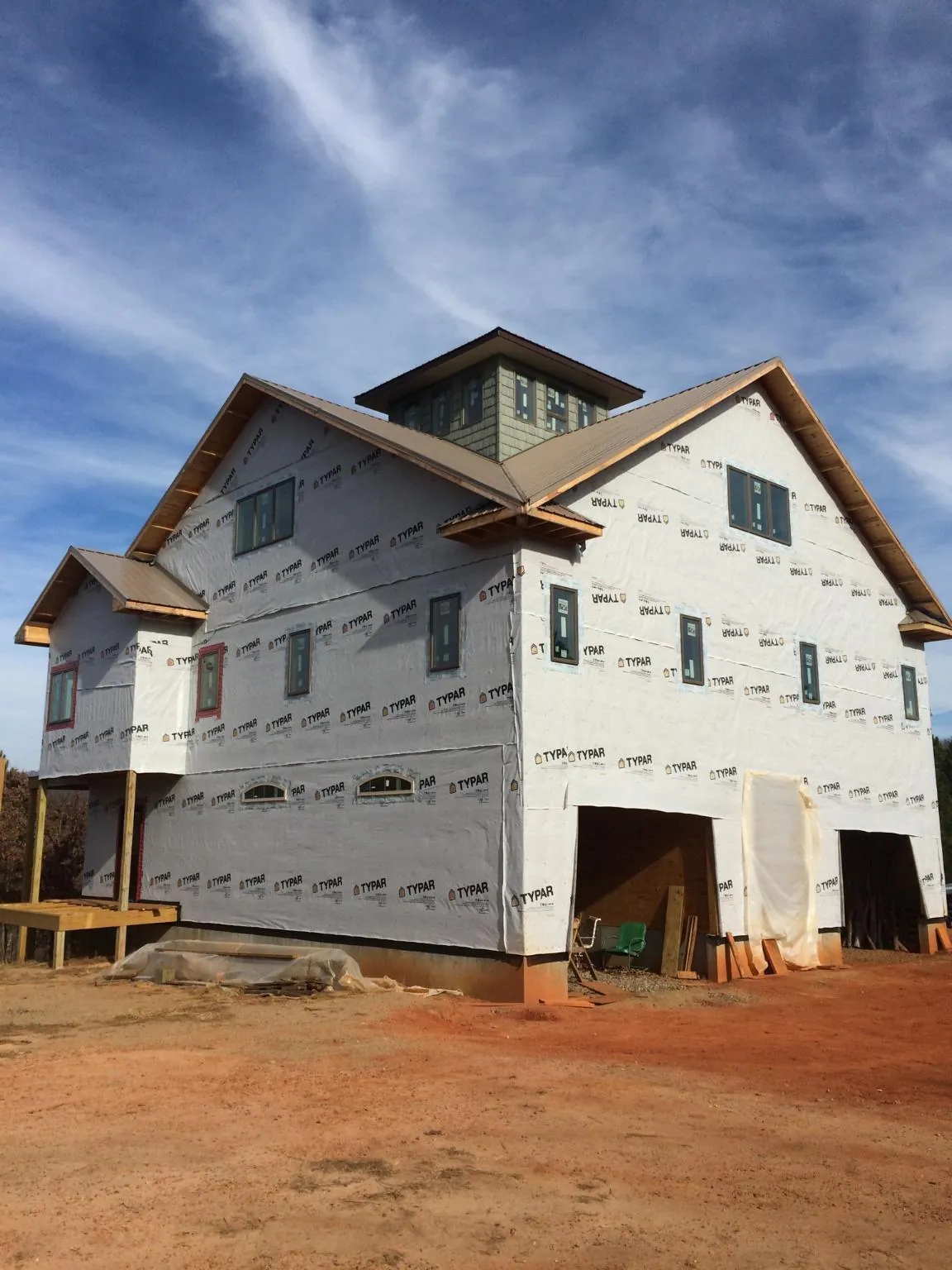 New two story house under construction with a cupola and gabled roofs in Elco
